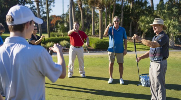 Doug Weaver demonstrating with a putter in front of a group at golf lessons at Palmetto Dunes Golf Academy