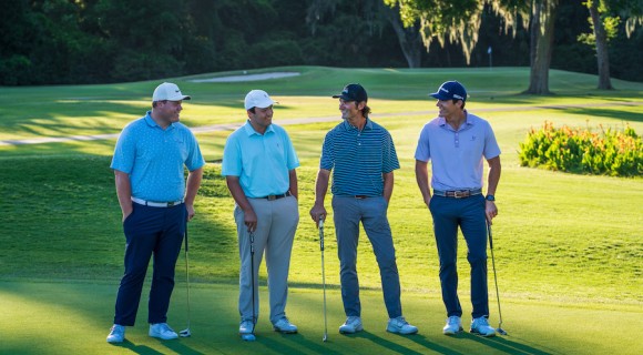 four male golfers on the George Fazio Golf Course smiling at each other