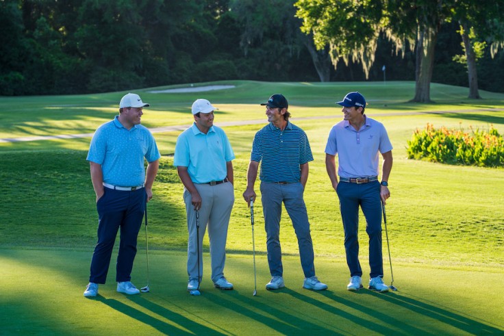 four male golfers on the George Fazio Golf Course smiling at each other
