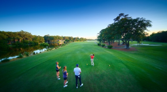 aerial view of two female and two male golfers watching a swing on the George Fazio Golf Course