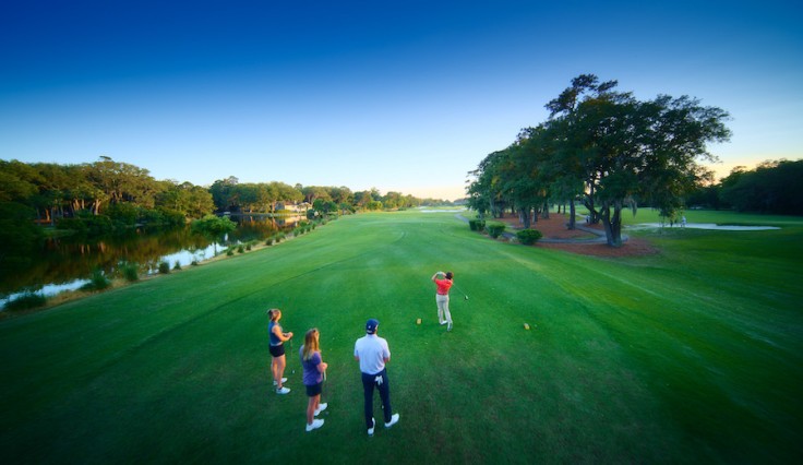aerial view of two female and two male golfers watching a swing on the George Fazio Golf Course