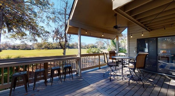outdoor seating and barstools on a private deck overlooking the Fazio Golf Course