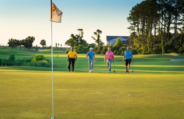 4 golfers walking