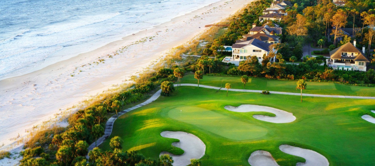 Aerial shot of golf course next to beach