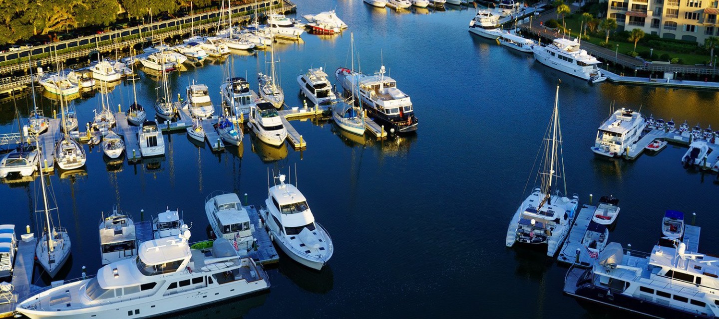 Aerial view of boats at Shelter Cover Marina at sunset.