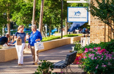 two women walking the Shelter Cove Harbour and Marina shops outside of the Southern Tide store