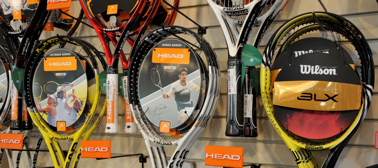 Wall display of tennis rackets at a pro shop