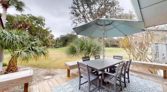 private deck of a Palmetto Dunes vacation rental with outdoor seating overlooking the golf course
