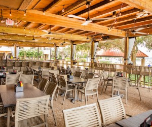 covered patio seating with waterfront views at Top Dawg Tavern
