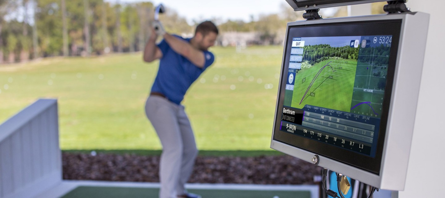 close up of toptracer technology screen with golfer in background