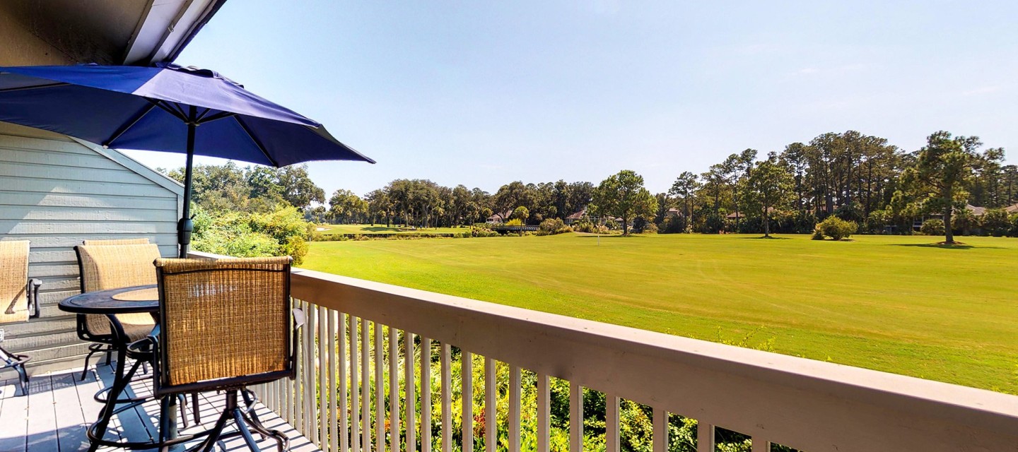 private balcony with chairs overlooking golf course