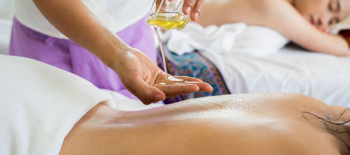 Closeup of person getting back massage with oil