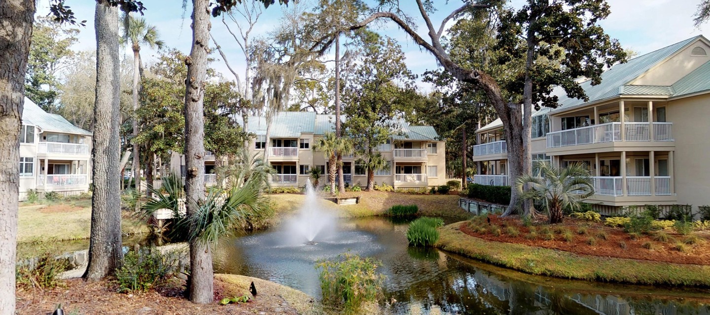 view of pond and buildings with balconies facing it in Barrington Park