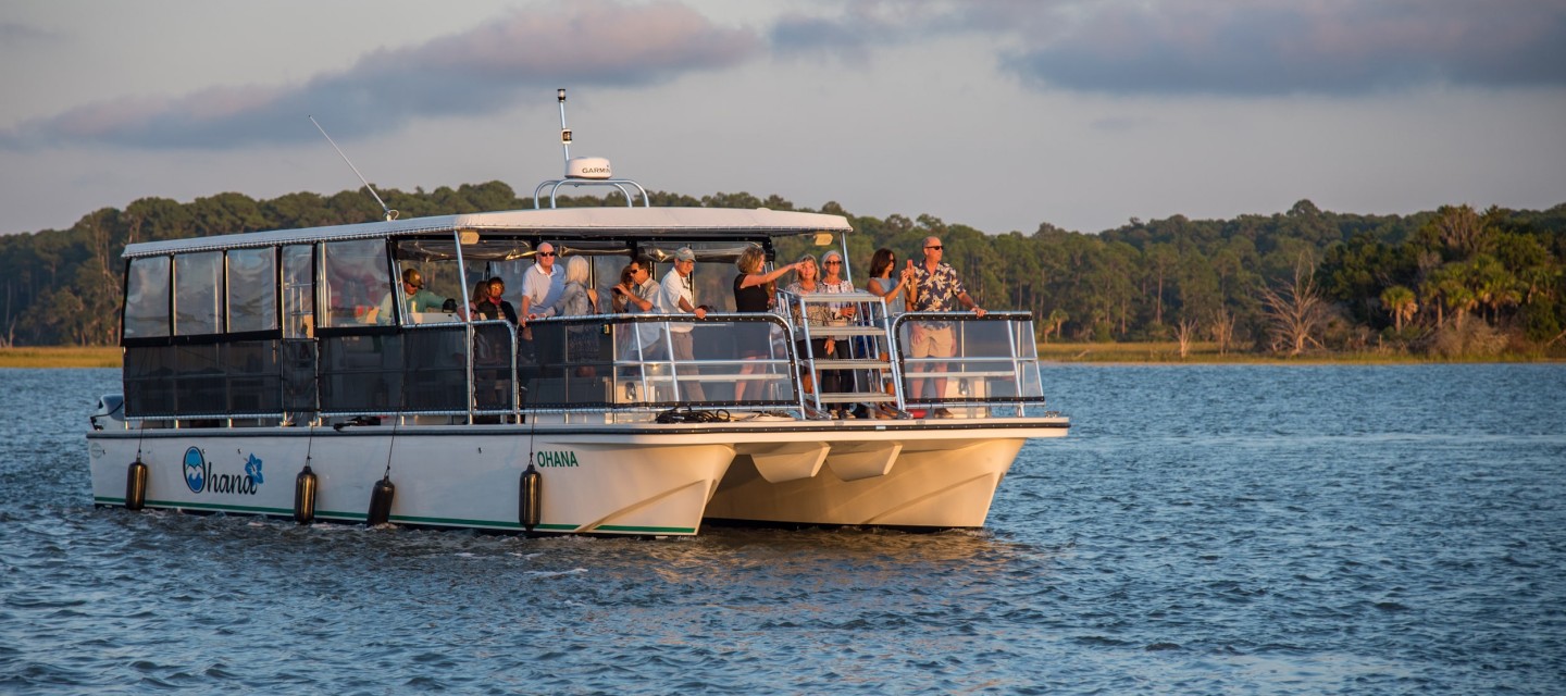 Ohana boat cruise at dusk in Shelter Cove Harbour